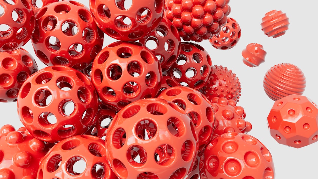Glossy red spheres in space - Abstract by Best 3D Printer a pile of red plastic balls with holes on them